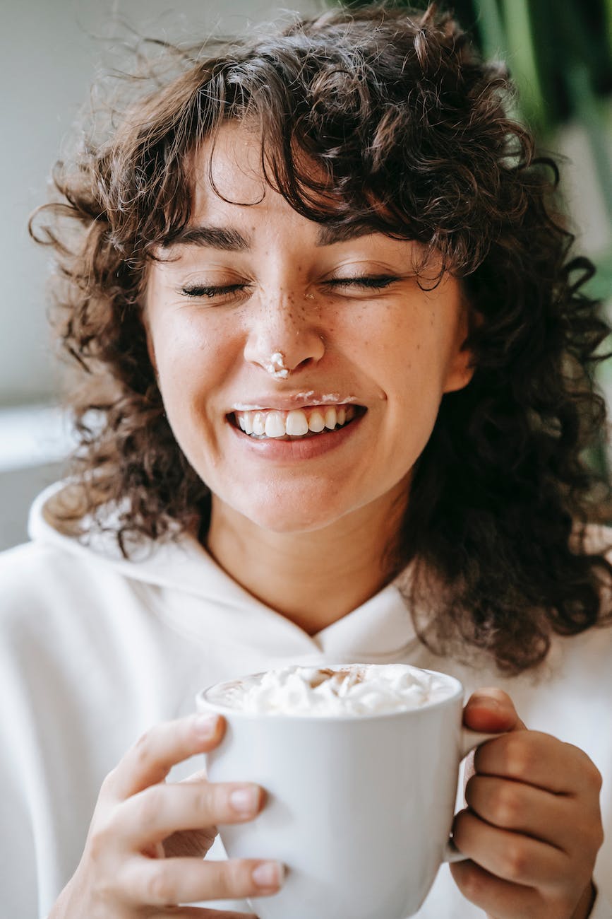 Root Canal Experts in Thane 5 cheerful woman with cream on nose and cup of coffee
